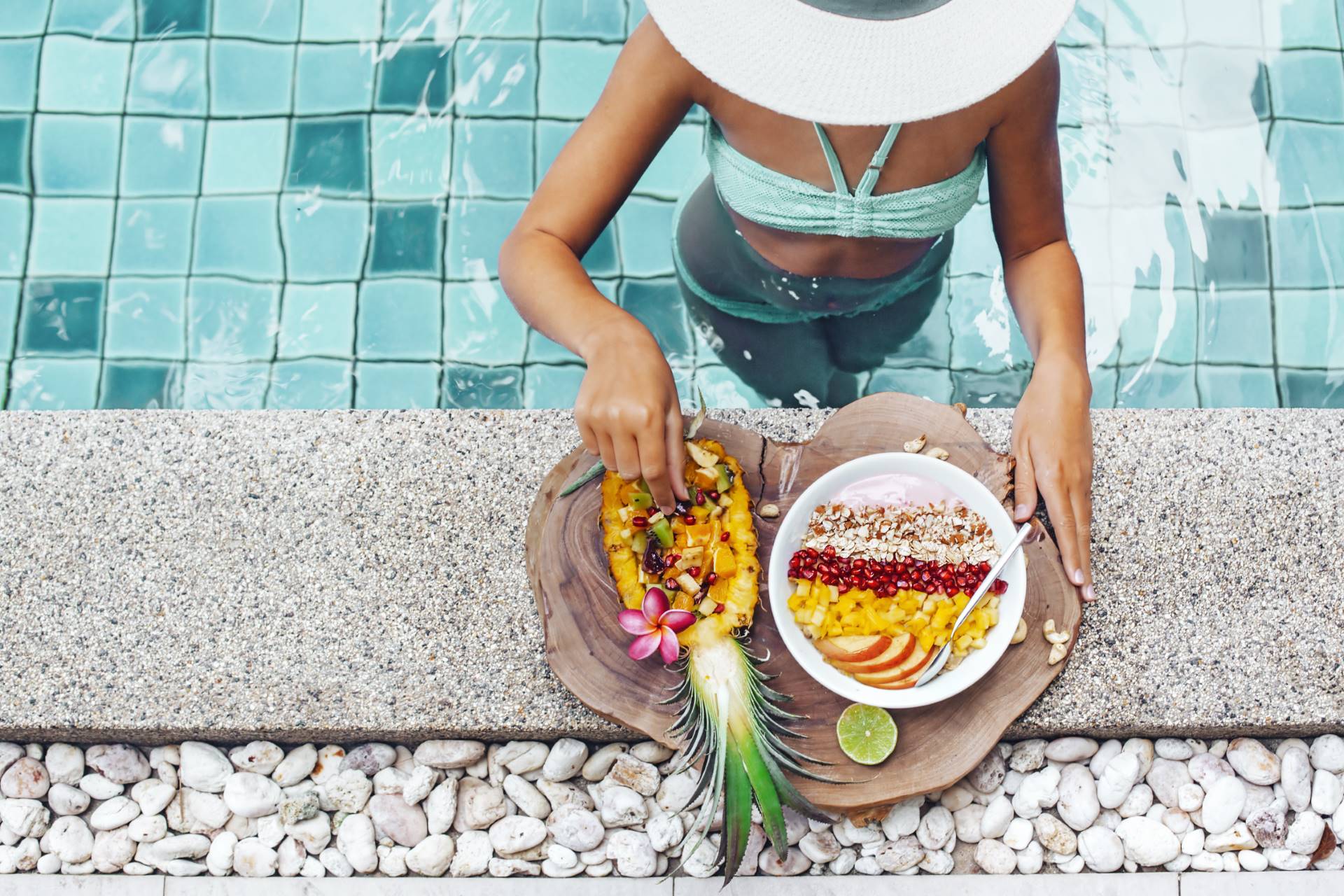 girl eating exotic fruits in the pool