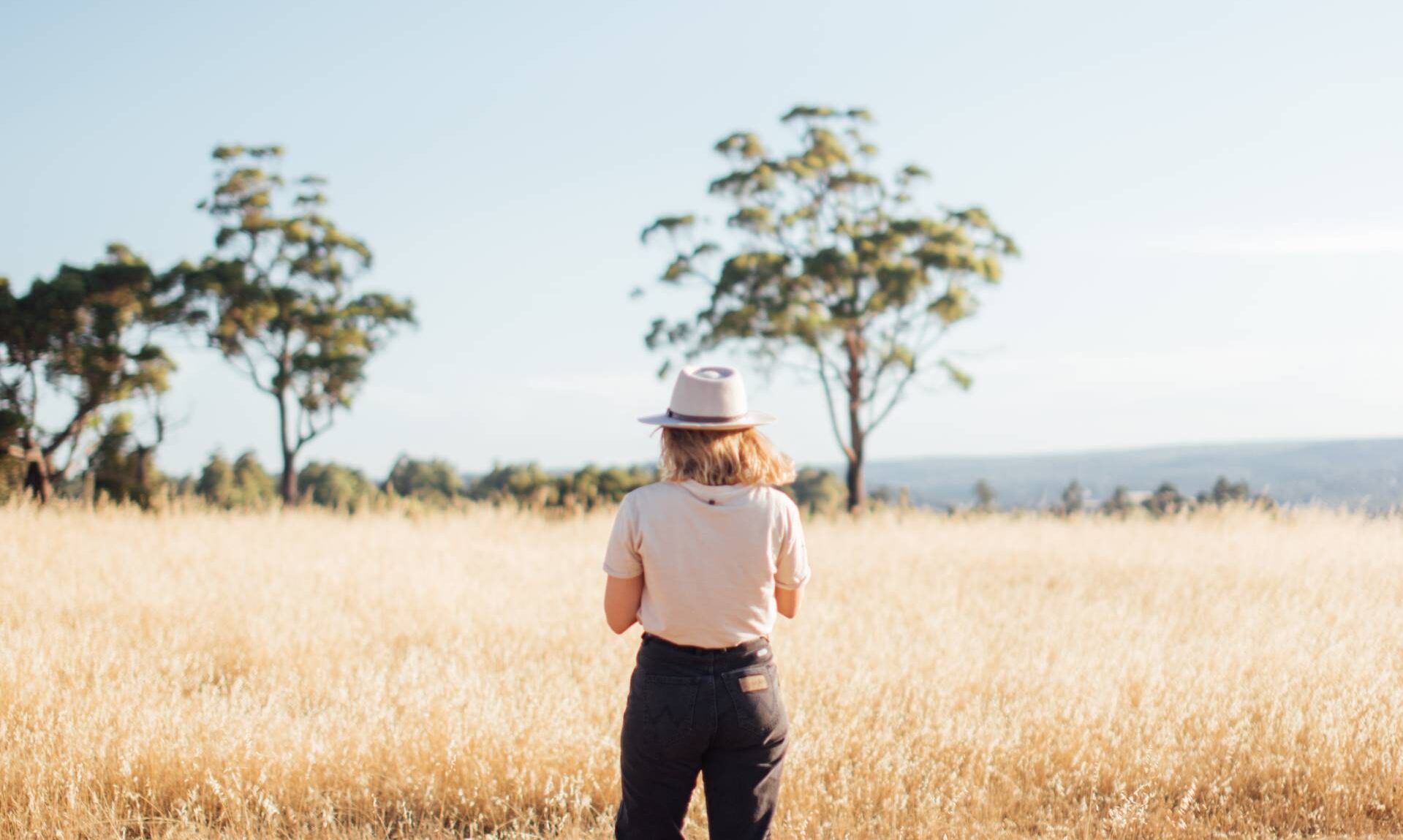 canva woman standing in the middle of the farm field (1920)